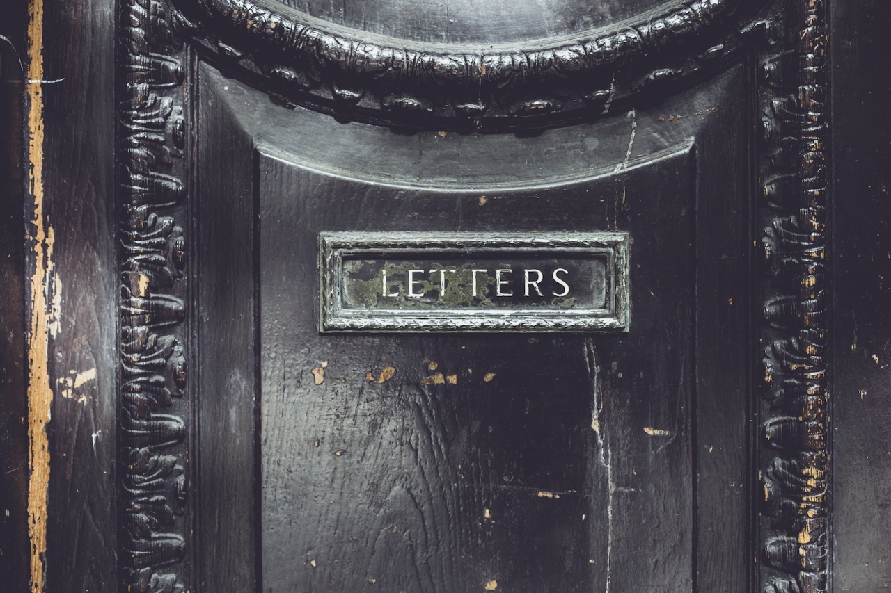A black door with a sign that says letters